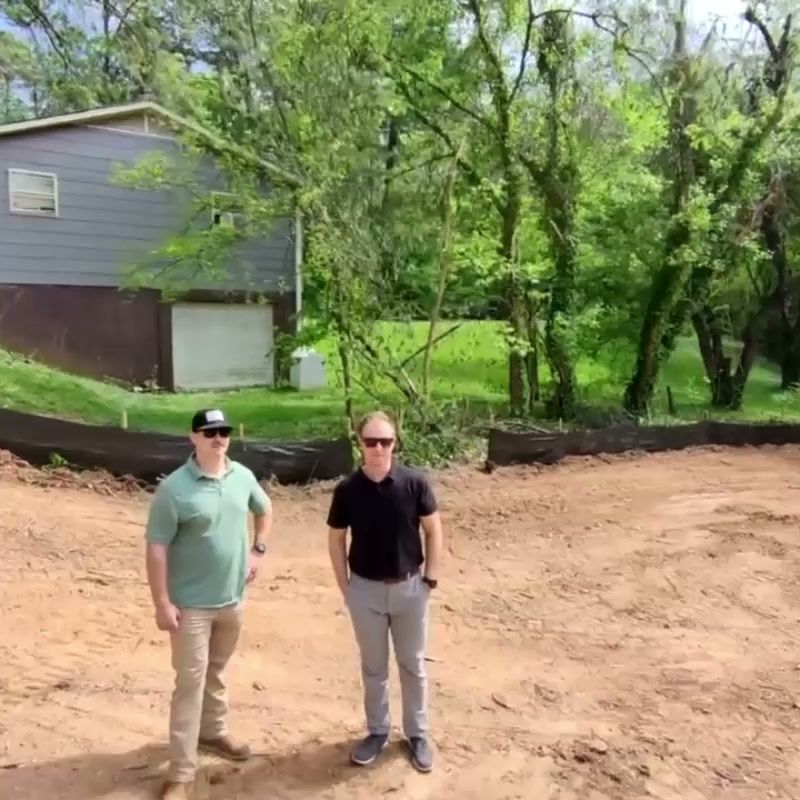 The cleared Dewine Road lot with the D&H team standing on the graded pad